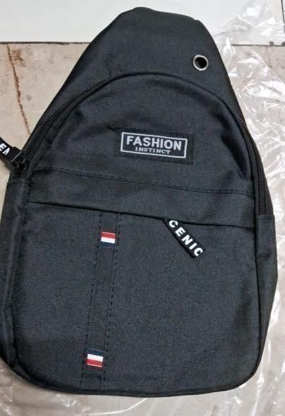 Black men's sling bag with zippered pocket, fabric tags, and minimalist design.