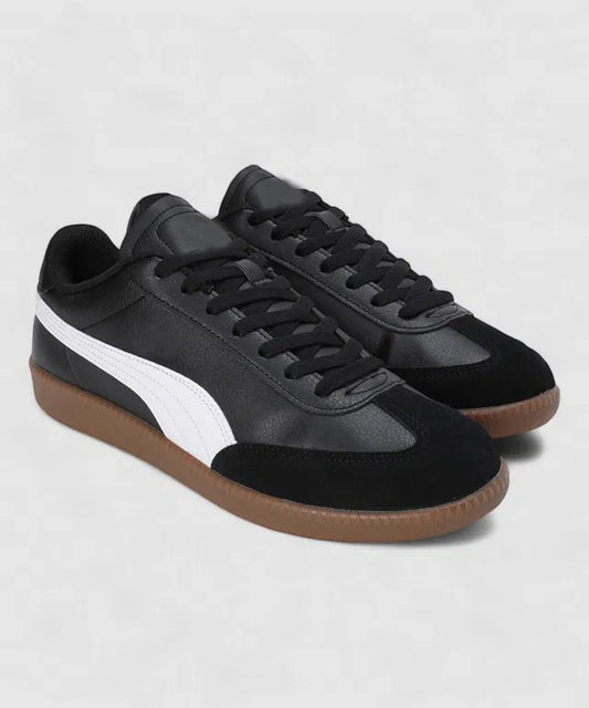 Black leather sneakers with a white side stripe, a black suede toe cap, and a classic gum rubber out sole.