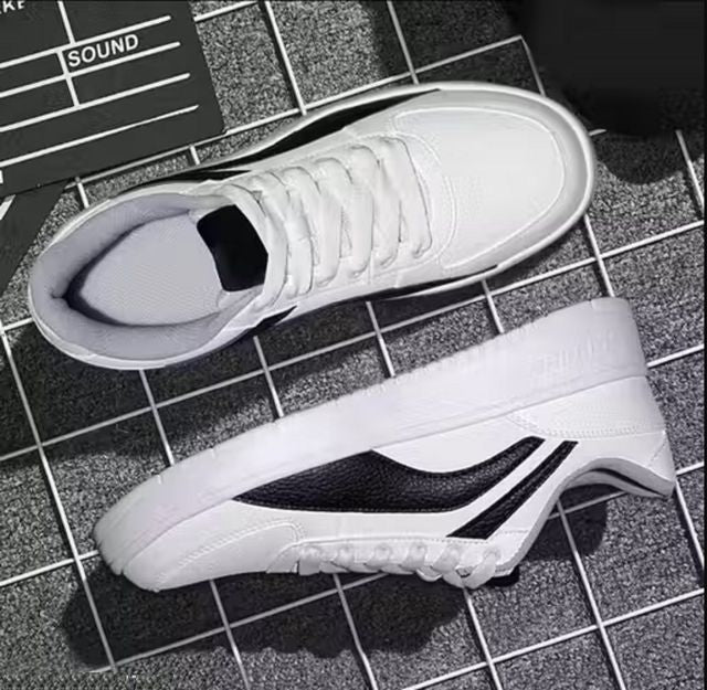 Men's white low-top sneakers with a bold black side panel, featuring flat white rubber soles