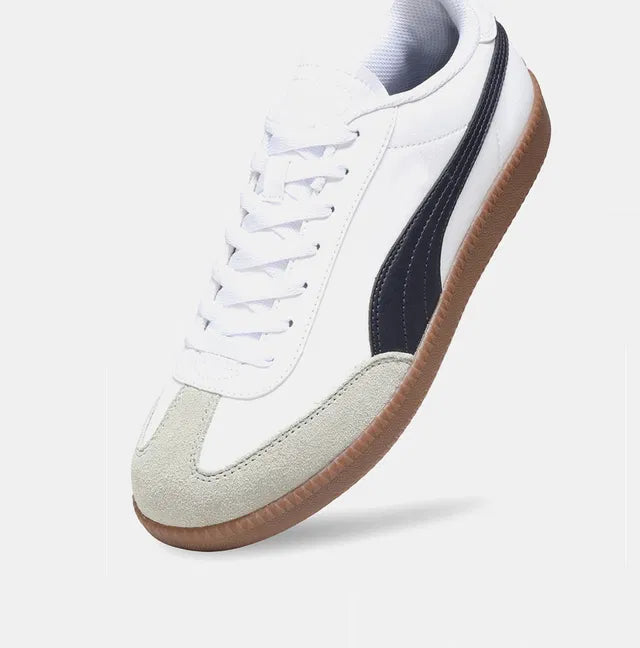 white men's sneaker featuring a signature black side stripe, a grey suede T-toe overlay, and a vintage-style gum rubber sole.