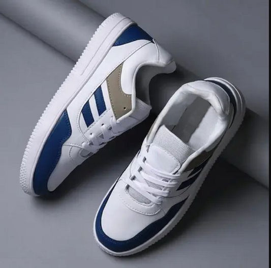 Premium men’s white sneaker featuring bold navy blue stripes and a khaki tan accent panel, highlighting the clean stitching and durable white mid sole.