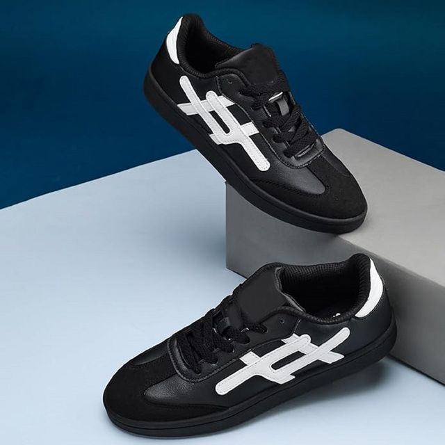 black leather sneakers with black suede toe caps, white side branding, and solid black out soles.