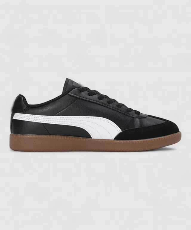 Black leather sneakers with a white side stripe, a black suede toe cap, and a classic gum rubber out sole.