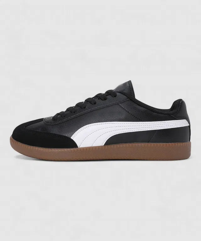 Black leather sneakers with a white side stripe, a black suede toe cap, and a classic gum rubber out sole.