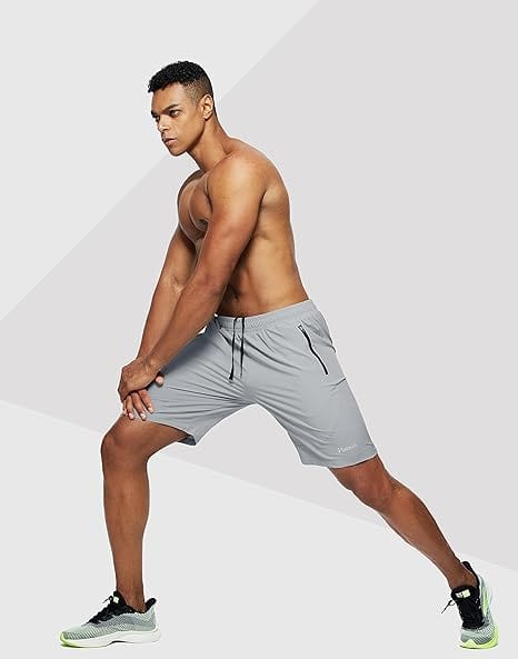 Athletic man stretching in light grey men's stretchable cotton shorts with drawstring waist
