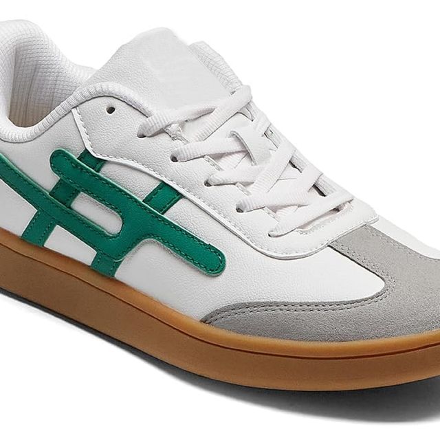 white leather sneakers with grey suede toe caps, emerald green side branding, and tan gum rubber soles