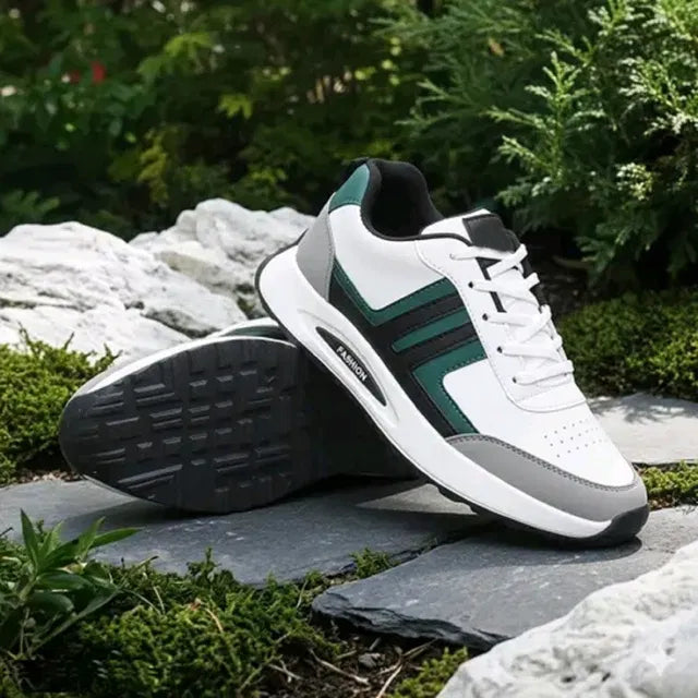 A premium white men's sports sneaker with dark green and grey accents, featuring a thick cushioned sole
