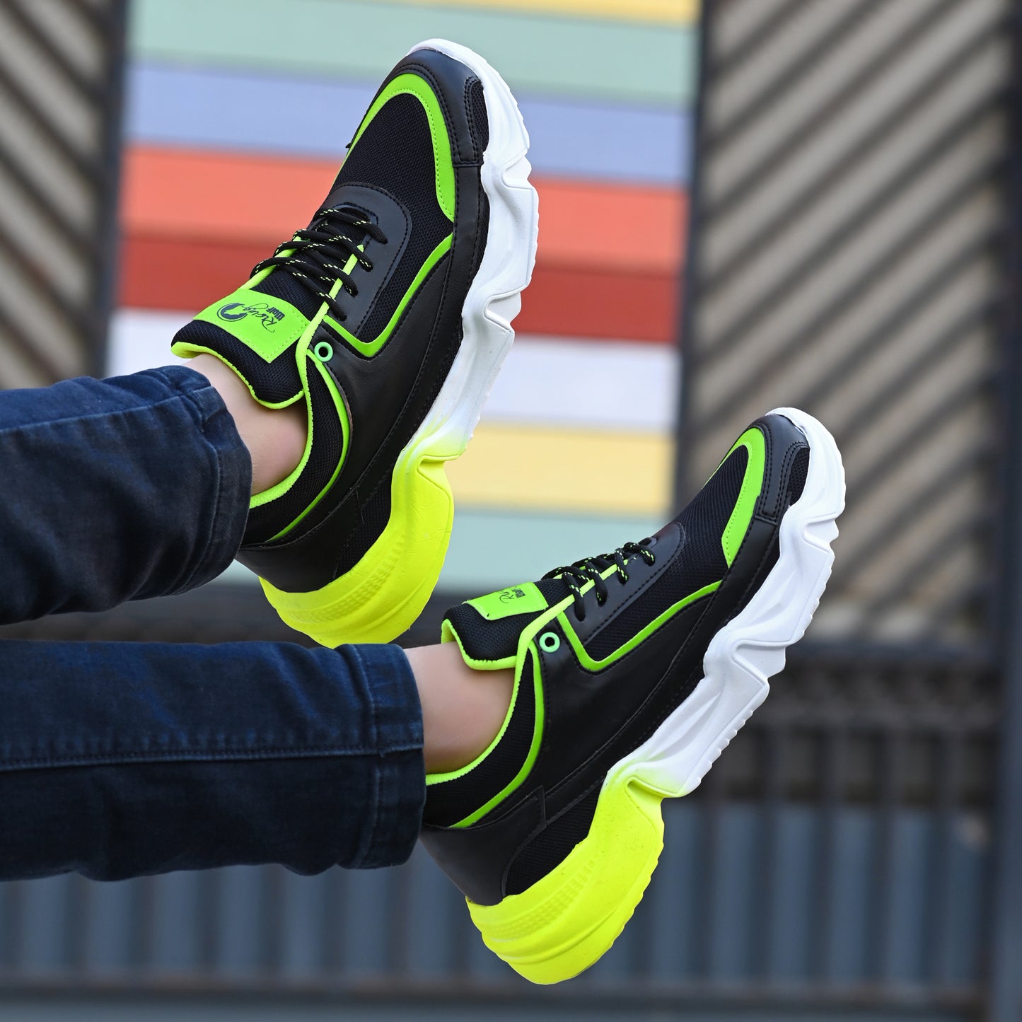 neon green and black chunky sport sneakers with a white and yellow gradient wavy sole