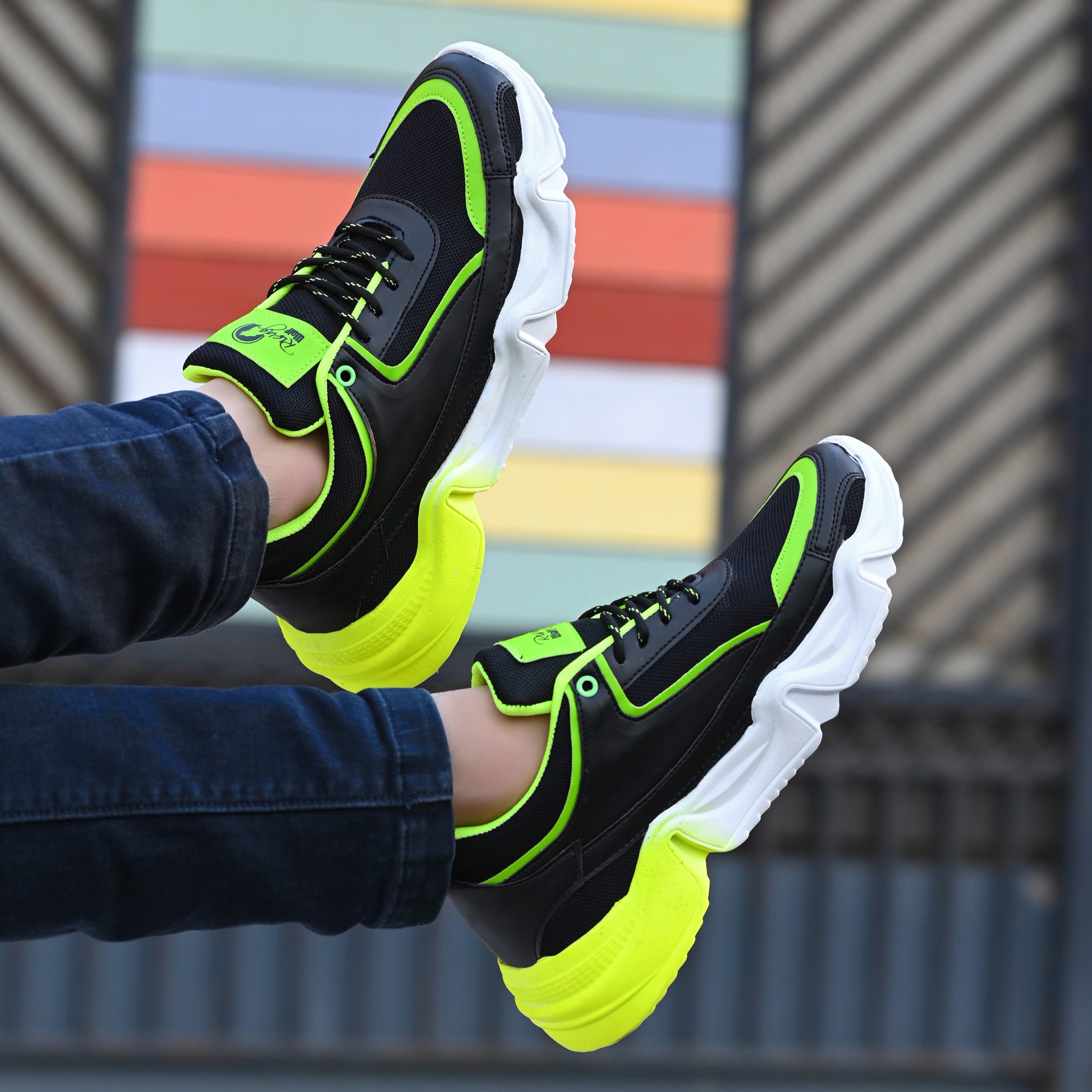 neon green and black chunky sport sneakers with a white and yellow gradient wavy sole
