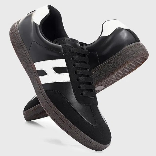 black and white men's casual sneakers with a textured gum sole and a bold white 'H' logo on the side