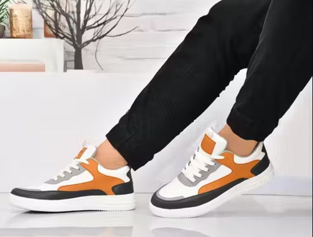 Men's multi-colour sneakers featuring white, tan, and grey patchwork panels with a thick white textured 'AIR' sole and white laces