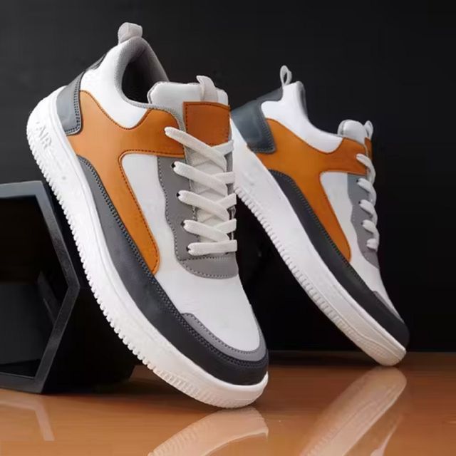Men's multi-colour sneakers featuring white, tan, and grey patchwork panels with a thick white textured 'AIR' sole and white laces
