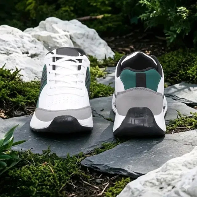 A premium white men's sports sneaker with dark green and grey accents, featuring a thick cushioned sole