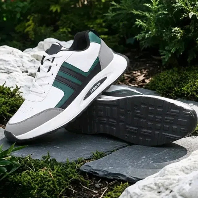 A premium white men's sports sneaker with dark green and grey accents, featuring a thick cushioned sole