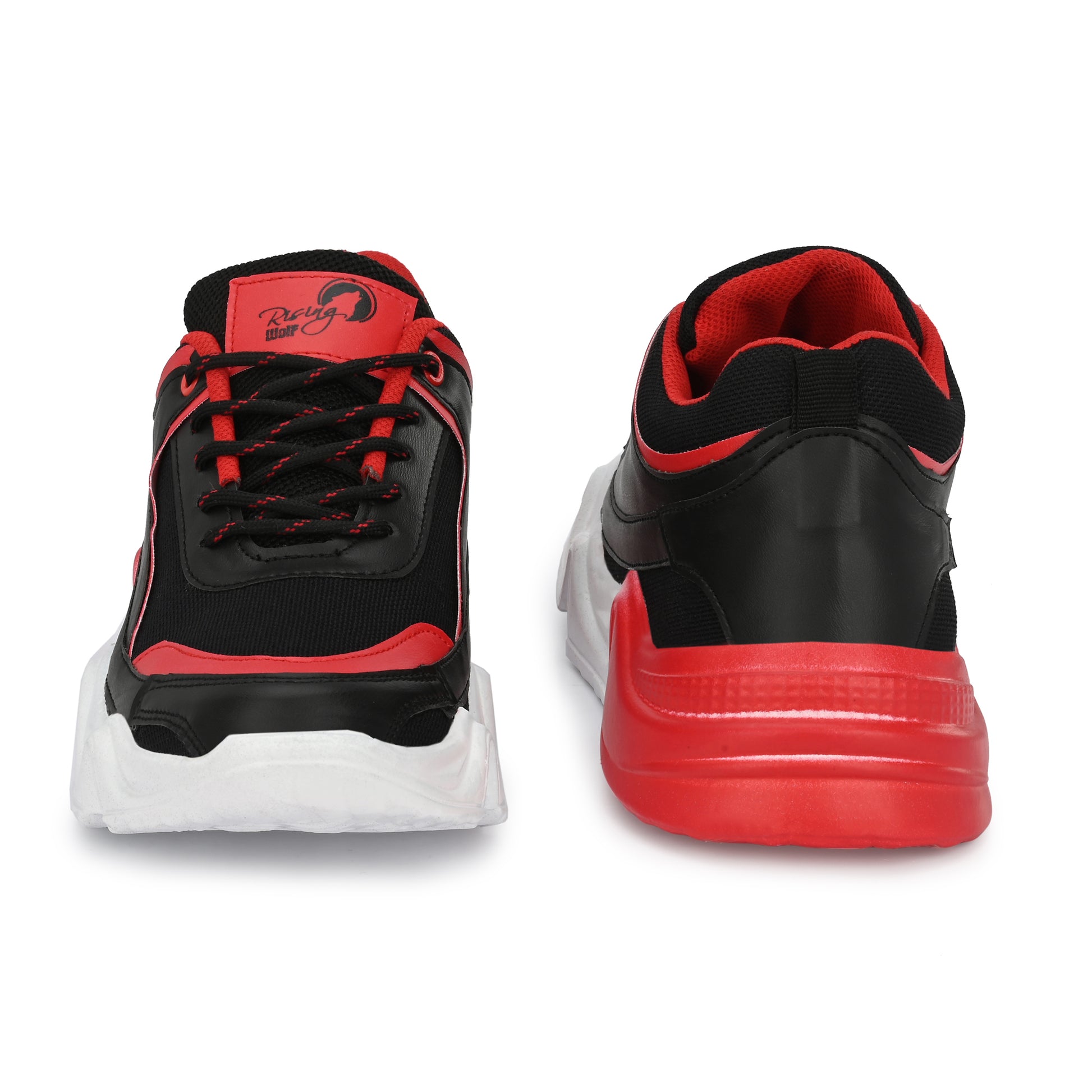 Rising Wolf men's chunky sneakers in black and red with a thick white wavy sole, styled with green joggers on a paved walk.
