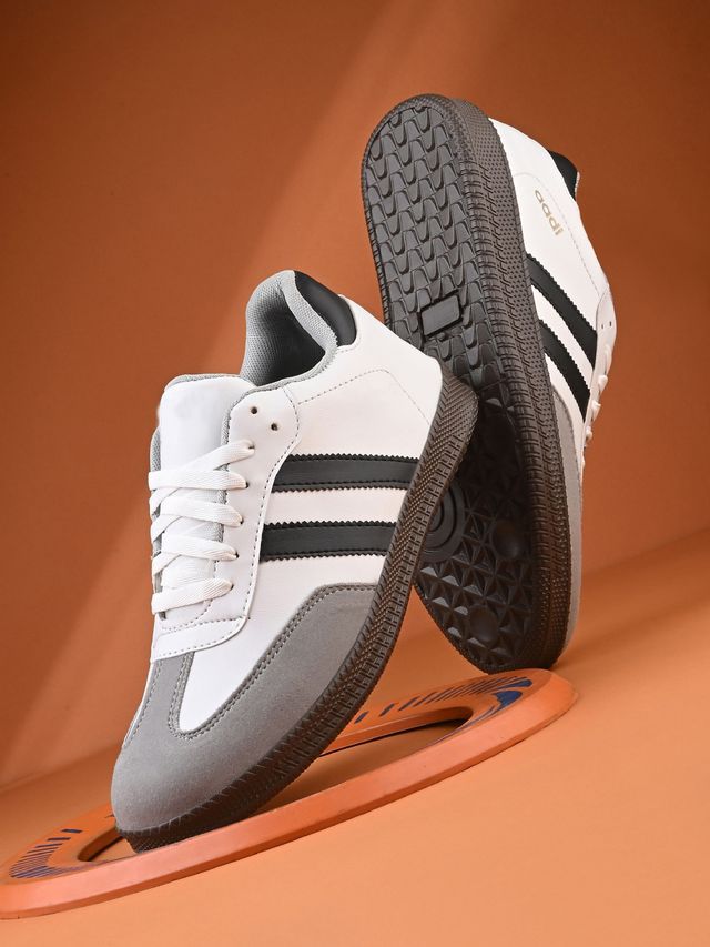 Men's casual white sneakers with black stripes and grey suede toe cap, featuring a durable textured brown rubber sole for grip and style.