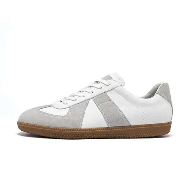 White leather German Army Trainer style sneakers with light grey suede overlays and a gum rubber sole.