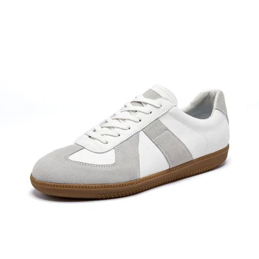 White leather German Army Trainer  style sneakers with light grey suede overlays and a gum rubber sole.