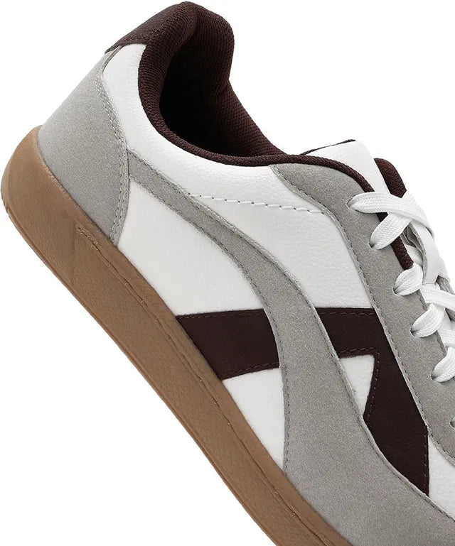 White leather sneakers with grey suede overlays, brown side stripes, and a dark brown gum rubber sole