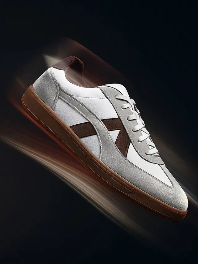 White leather sneakers with grey suede overlays, brown side stripes, and a dark brown gum rubber sole
